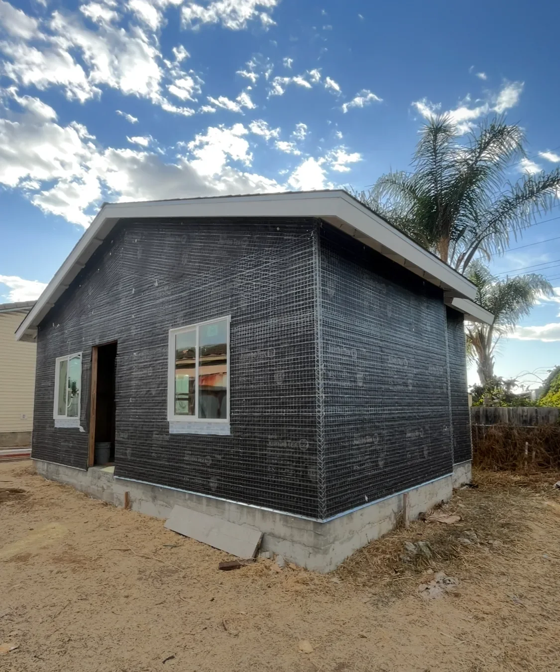 Exterior building wall during stucco lath preparation